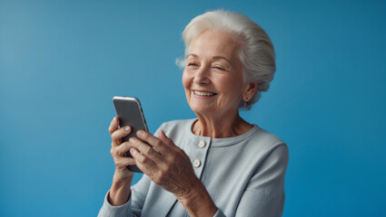 Smiling elderly woman using smartphone, blue background