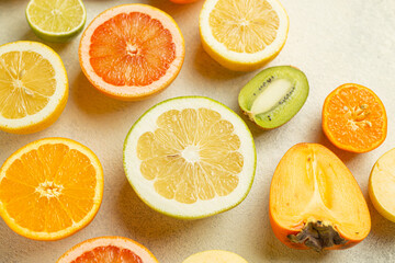 A close up of various types of fruit, including oranges, grapefruit, kiwi, and apples