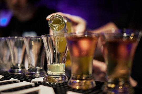 Bartender Preparing Cocktails at a Bar Counter