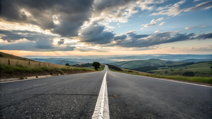 Naklejka premium Captivating view of a highway stretching into the horizon amidst rolling landscapes 