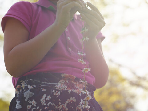 girl playing with wildflowers