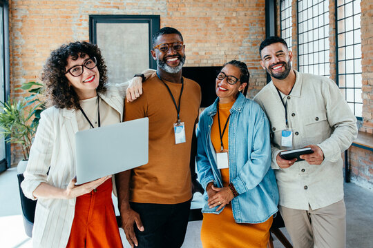 Smiling diverse team of professionals collaborating in a modern office environment
