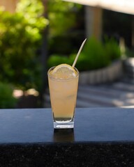 Indonesian orange ice served on a wooden table with a garden view