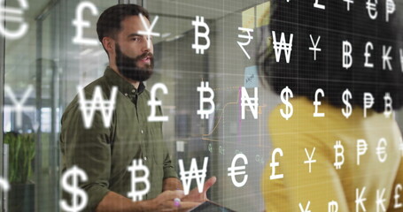 Image of currency symbols over diverse colleagues discussing work in office