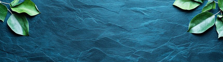 Obraz premium textured teal background with green leaves creates serene and natural atmosphere, perfect for design projects or presentations