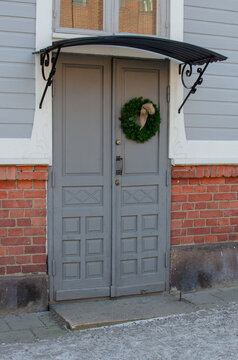 The traditional door of an old house, adorned with a Christmas wreath, Christmas decoration, reath