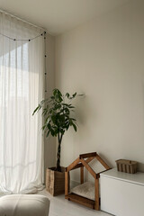 Living room interior with green plant and a dog house. 