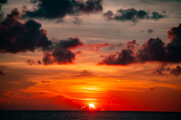 Fototapeta premium Amazing colorful clouds in sunset or sunrise sky over sea nature landscape background