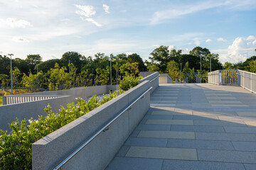 Walking pathway in green city public park office building sunset sky cloud
