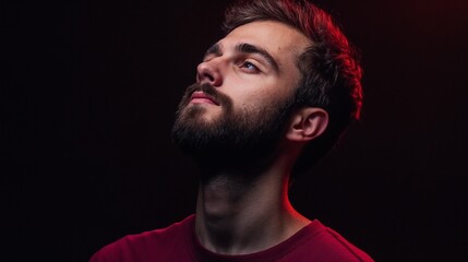 Obraz premium Dramatic portrait of bearded man in red lighting. Ideal for artistic portraiture, mood photography, and creative expression