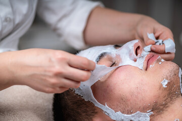 Man enjoying a plant based facial mask treatment at a beauty cen