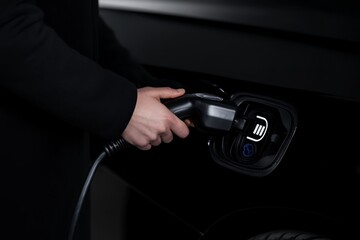 Fototapeta premium Charging an electric vehicle at a modern charging station