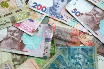 Big amount of different ukrainian hryvnia currency money bills in pile