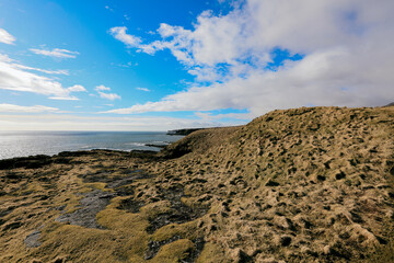 Scenic view from Fowlsheugh Nature Reserve showcasing rocky coastline and blue skies