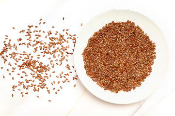 Flax Seeds in a Tray and on a White Background