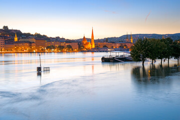 Panorama of Budapest across the flooded river at night