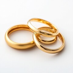 Trio of elegant gold rings on clean white background reflecting timeless beauty