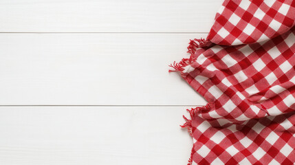 Obraz premium Red Gingham Tablecloth: A classic red and white checkered tablecloth drapes elegantly over a rustic wooden table, inviting you to create a warm and inviting atmosphere.