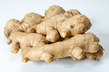 Fresh organic ginger rhizome root used in traditional medicines and for flavoring meals, drinks, isolated on white
