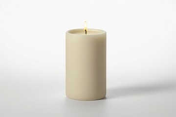 a close up of a lit candle on a white surface