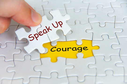 Speak Up and Courage text on jigsaw puzzle. Cultivating Speak Up Culture concept