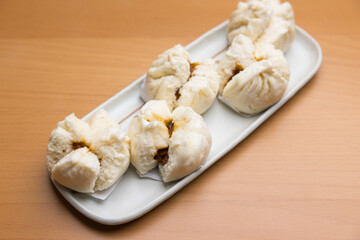 Plate of delicious steamed pork buns served