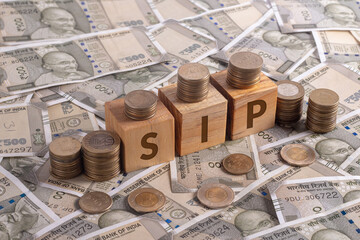SIP Word on Wooden Cubes with Indian Currency and Coins | Financial Investment Concept