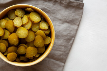 Organic Green Pickle Chips in a Bowl, top view. Flat lay, overhead, from above. Copy space.