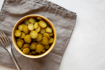 Organic Green Pickle Chips in a Bowl, top view. Flat lay, overhead, from above.