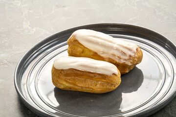 Delicous eclair with ising and cream