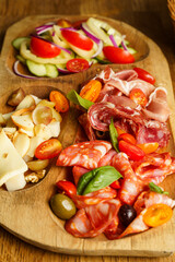 Charcuterie board with bread, cheese, and salad