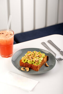 Avocado toast with seed and cashew nuts on breakfast table