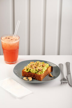 Avocado toast with seed and cashew nuts on breakfast table
