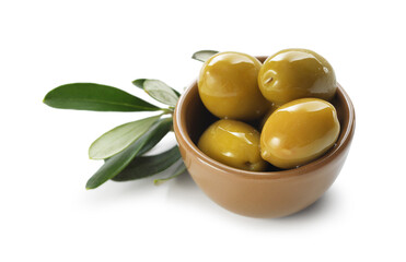Delicious marinated green olives in bowl and leaves isolated on white
