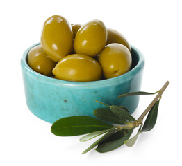 Delicious marinated green olives in bowl and leaves isolated on white