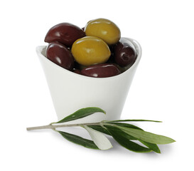 Delicious marinated olives in bowl and leaves isolated on white
