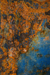 Rusty metal surface with shabby background paint. Blue cracked paint texture on an iron sheet. Fragment of an old metal door, Metal corrosion.