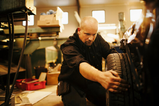 Middle aged caucasian mechanic working in a mechanics shop