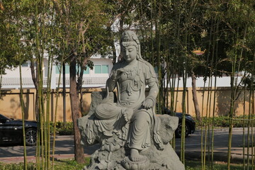 Stone statues at Fo Guang Shan Tai Hua Si, Bangkok. Buddhist figures, garden setting, religious art.