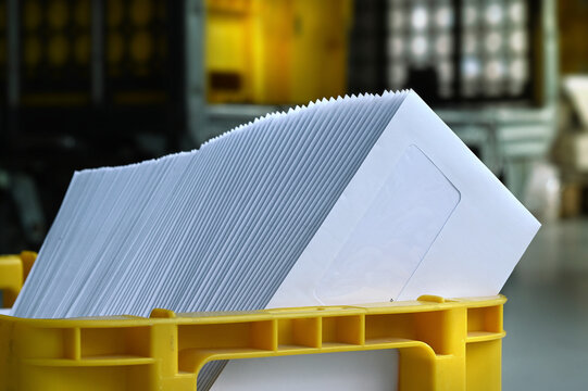 Mailbox with letter mailing sorted by zip code for delivery and postage optimization when sending mail. Inserting machine mail letter print production business.