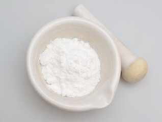 Caffeine powder on the light gray background