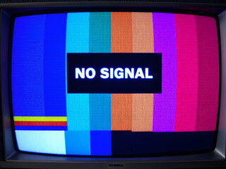 TV screen displaying "NO SIGNAL" with blue static noise in the background.