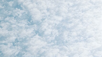 Obraz premium Cotton Candy Sky: A captivating aerial view of billowing white clouds against a serene blue sky evokes a sense of peace and tranquility, perfect for minimalist designs and calming visuals.