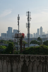 Obraz premium Cellular Towers and Water Tanks Overlooking the City