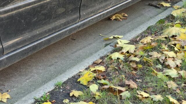 Abandoned car lower part with flat tires at autumn day