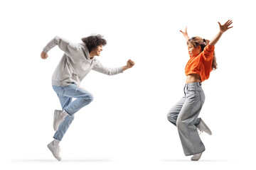 Full length profile shot of a young asian woman and a guy dancing