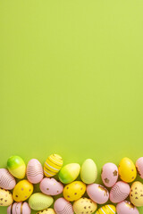 Decorative vertical pastel Easter eggs displayed against a green backdrop, evoking a festive and celebratory atmosphere with vibrant colors and cheerful ornamentation for holiday-themed designs