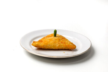 Mayo rissoles are triangular in shape, on a white plate, with chili on top