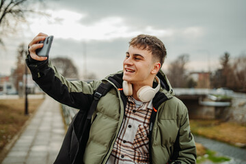 Young adult man student smiling take self portrait or video call