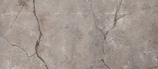 Fototapeta premium Cracked concrete surface with a linear pattern, illuminated by natural light